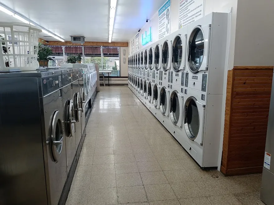 The main aisle between stainless front-loaders and stacked dryers