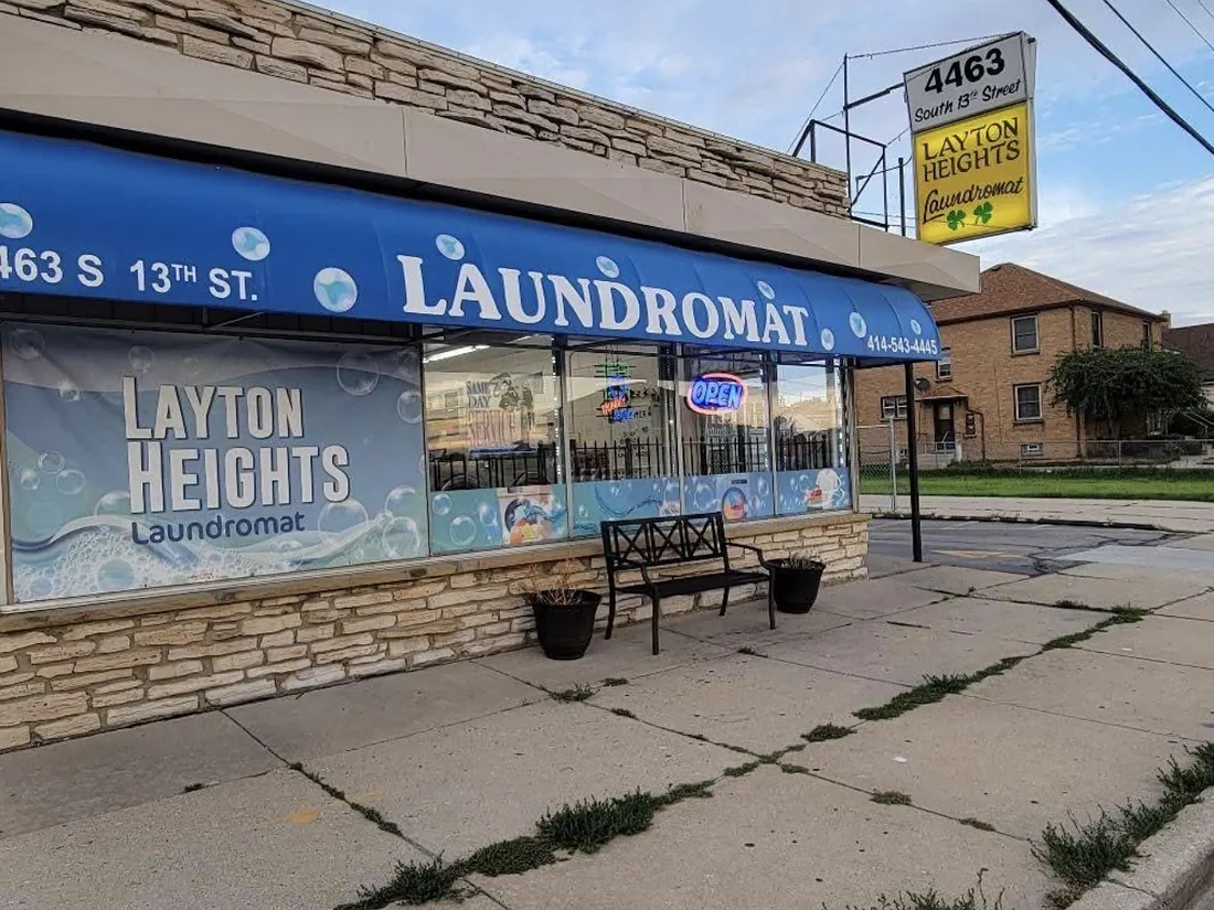 The Layton Heights Laundromat storefront on South 13th Street, with a blue awning and a yellow sign